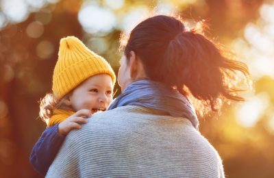 Happy family on autumn walk! Mother and daughter walking in the Park and enjoying the beautiful autumn nature.